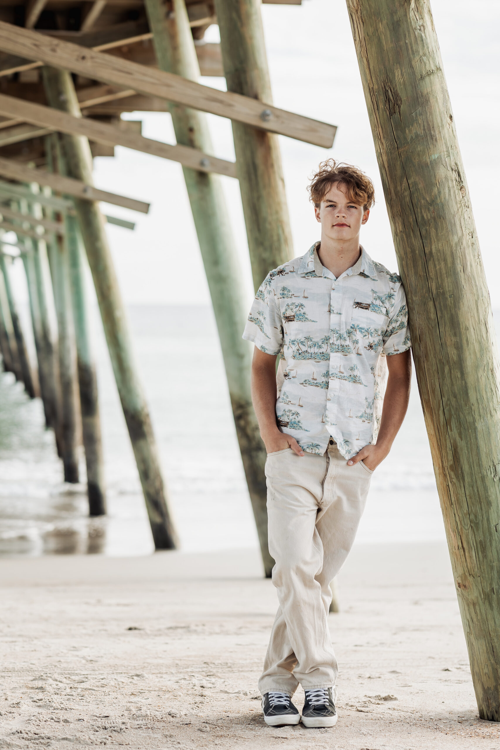 High school senior boy portrait on the beach at Emerald Isle NC during a coastal senior photography session by Greenville NC senior photographer